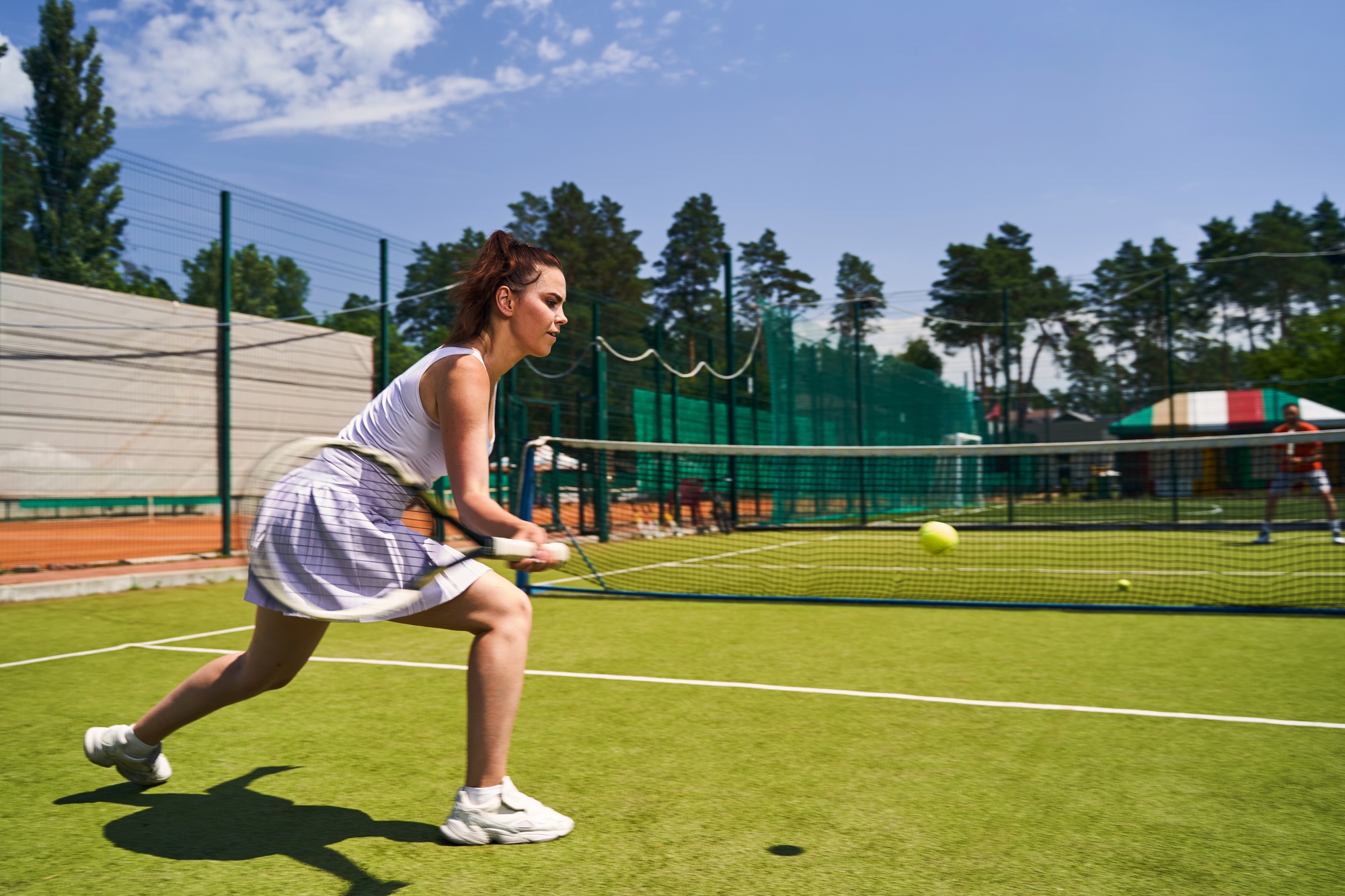 Attractive sportswoman playing a singles match with her opponent