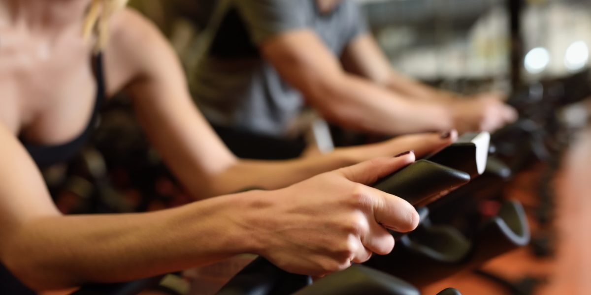 Couple in a spinning class wearing sportswear.