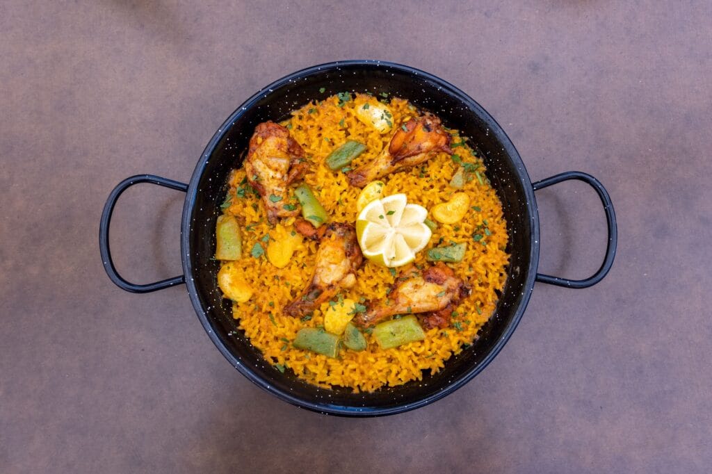 Top view of Paella served on a pan in a restaurant