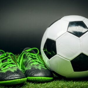 soccer ball and cleats on the football field